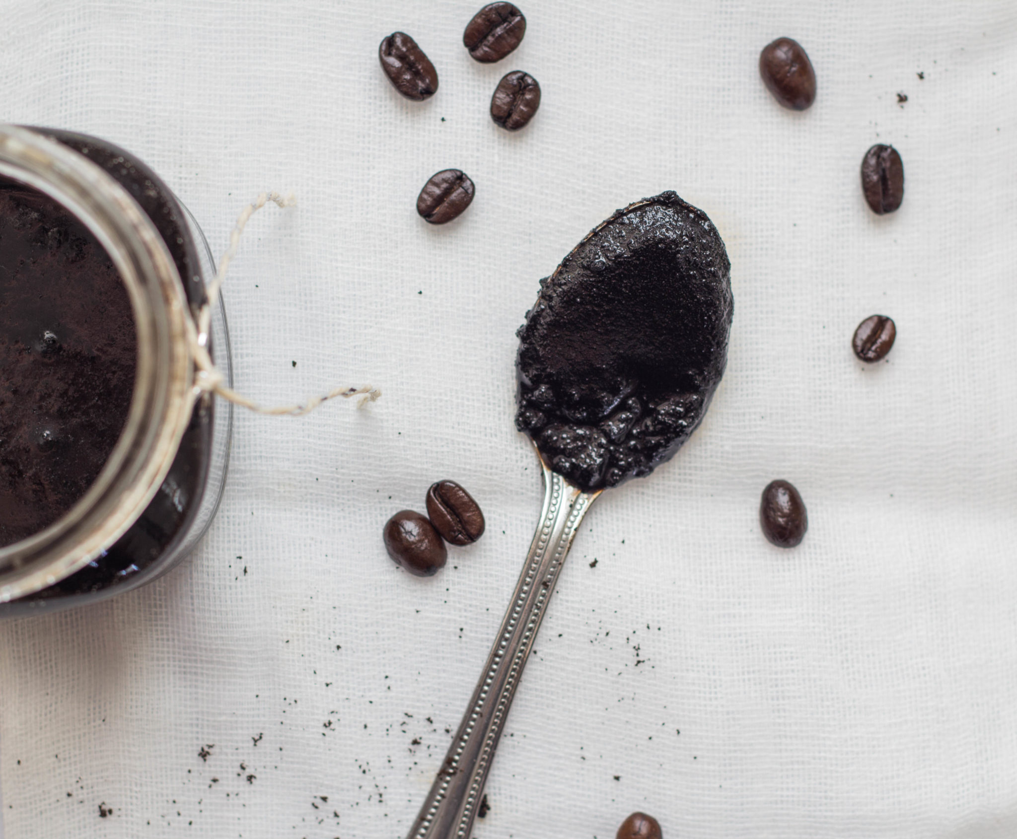 coffee beans and coffee grounds on spoon